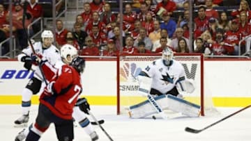 Oct 13, 2015; Washington, DC, USA; San Jose Sharks goalie Martin Jones (31) makes a save on Washington Capitals right wing T.J. Oshie (77) in the third period at Verizon Center. The Sharks won 5-0. Mandatory Credit: Geoff Burke-USA TODAY Sports