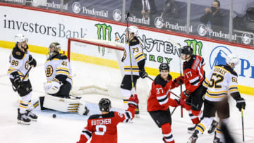 May 4, 2021; Newark, New Jersey, USA; New Jersey Devils center Pavel Zacha (37) celebrates with defenseman Will Butcher (8) and center Yegor Sharangovich (17) after scoring the game winning goal past Boston Bruins goaltender Jaroslav Halak (41) in overtime at Prudential Center. Mandatory Credit: Vincent Carchietta-USA TODAY Sports