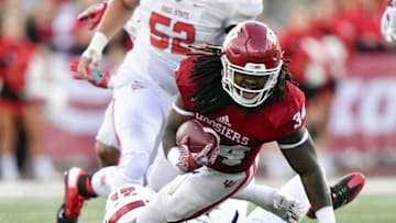 Sep 10, 2016; Bloomington, IN, USA; Indiana Hoosiers running back Devine Redding (34) dives while being tackled by Ball State Cardinals safety Martez Hester (21) during the second half of the game at Memorial Stadium. The Indiana Hoosiers defeated the Ball State Cardinals 30 to 20. Mandatory Credit: Marc Lebryk-USA TODAY Sports