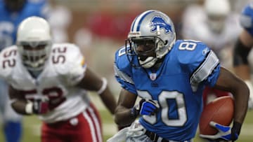 DETROIT, MI - SEPTEMBER 7: Rookie wide receiver Charles Rogers #80 of the Detroit Lions runs the ball as linebacker Levar Fisher #52 of the Arizona Cardinals tries to catch Rogers at Ford Field on September 7, 2003 in Detroit, Michigan. The Lions defeated the Cardinals 42-24. (Photo by Danny Moloshok/Getty Images)
