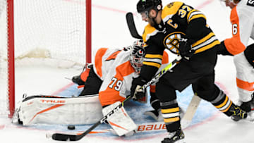 Jan 21, 2021; Boston, Massachusetts, USA; Philadelphia Flyers goaltender Carter Hart (79) blocks a shot from Boston Bruins center Patrice Bergeron (37) during the second period at the TD Garden. Mandatory Credit: Brian Fluharty-USA TODAY Sports