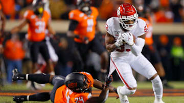 STILLWATER, OK - NOVEMBER 30: Wide receiver Nick Basquine #83 of the Oklahoma Sooners gets tackled by the shirt tail by safety Jarrick Bernard #24 of the Oklahoma State Cowboys on a nine-yard catch for a first down in the third quarter on November 30, 2019 at Boone Pickens Stadium in Stillwater, Oklahoma. OU won 34-16. (Photo by Brian Bahr/Getty Images)