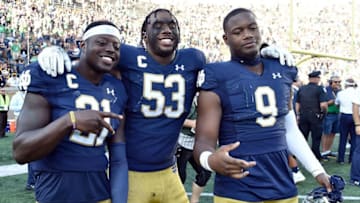 SOUTH BEND, INDIANA - SEPTEMBER 14: Jalen Elliott #21, Khalid Kareem, and Daelin Hayes #9 of the Notre Dame Fighting Irish pose to celebrate the victory against the New Mexico Lobos at Notre Dame Stadium on September 14, 2019 in South Bend, Indiana. (Photo by Quinn Harris/Getty Images)