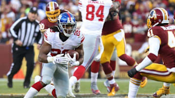 Jan 1, 2017; Landover, MD, USA; New York Giants running back Paul Perkins (28) carries the ball as Washington Redskins safety Will Blackmon (41) prepares to make the tackler in the first quarter at FedEx Field. Mandatory Credit: Geoff Burke-USA TODAY Sports