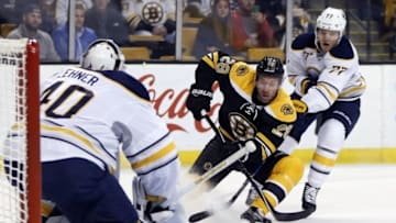 Nov 7, 2016; Boston, MA, USA; Boston Bruins center Dominic Moore (28) is defended by Buffalo Sabres defenseman Dmitry Kulikov (77) during the first period at TD Garden. Mandatory Credit: Greg M. Cooper-USA TODAY Sports