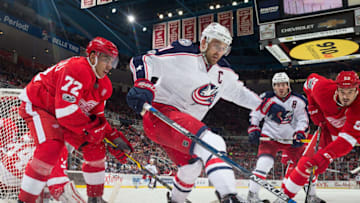 DETROIT, MI - FEBRUARY 07: Andreas Athanasiou #72 and Jonathan Ericsson #52 of the Detroit Red Wings battle for the puck with Nick Foligno #71 and Boone Jenner #38 of the Columbus Blue Jackets during an NHL game at Joe Louis Arena on February 7, 2017 in Detroit, Michigan. (Photo by Jennifer Hefner/NHLI via Getty Images)