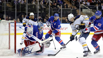 Henrik Lundqvist #30 of the New York Rangers looks to block a shot by Sam Reinhart #23 o(Photo by Abbie Parr/Getty Images)