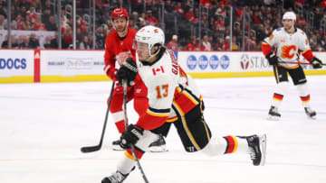 DETROIT, MICHIGAN - FEBRUARY 23: Johnny Gaudreau #13 of the Calgary Flames scores a first period goal on this shot in front of Frans Nielsen #81 of the Detroit Red Wings at Little Caesars Arena on February 23, 2020 in Detroit, Michigan. (Photo by Gregory Shamus/Getty Images)