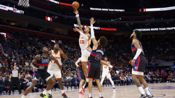 DETROIT, MICHIGAN - OCTOBER 26: John Collins #20 of the Atlanta Hawks goes up for a shot against Cade Cunningham #2 of the Detroit Pistons in the first half at Little Caesars Arena on October 26, 2022 in Detroit, Michigan. NOTE TO USER: User expressly acknowledges and agrees that, by downloading and or using this photograph, User is consenting to the terms and conditions of the Getty Images License Agreement. (Photo by Rick Osentoski/Getty Images)