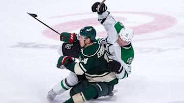 Oct 29, 2016; Saint Paul, MN, USA; Minnesota Wild forward Joel Eriksson Ek (14) checks Dallas Stars forward Antoine Roussel (21) in the third period at Xcel Energy Center. The Minnesota Wild beat the Dallas Stars 4-0. Mandatory Credit: Brad Rempel-USA TODAY Sports