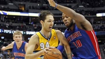 Mar 19, 2014; Denver, CO, USA; Detroit Pistons power forward Greg Monroe (10) guards Denver Nuggets shooting guard Evan Fournier (94) in the third quarter at the Pepsi Center. The Nuggets won 118-109. Mandatory Credit: Isaiah J. Downing-USA TODAY Sports