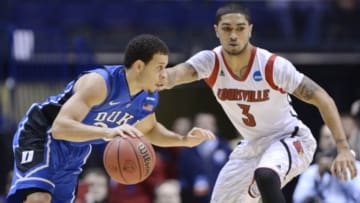 Mar 31, 2013; Indianapolis, IN, USA; Duke Blue Devils guard Seth Curry (left) drives against Louisville Cardinals guard Peyton Siva (3) in the first half during the finals of the Midwest regional of the 2013 NCAA tournament at Lucas Oil Stadium. Mandatory Credit: Jamie Rhodes-USA TODAY Sports