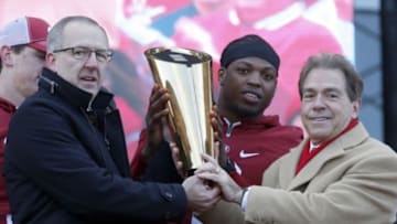 Jan 23, 2016; Tuscaloosa, AL, USA; Southeastern conference commissioner Greg Sankey holds the College Football Playoff trophy with Alabama running back Derrick Henry (2) and head coach Nick Saban during a presentation to celebrate the victory in the CFP National Championship game at Bryant-Denny Stadium. Mandatory Credit: Butch Dill-USA TODAY Sports