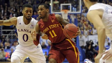 Mar 5, 2016; Lawrence, KS, USA; Iowa State Cyclones guard Monte Morris (11) dribbles the ball as Kansas Jayhawks guard Frank Mason III (0) and guard Evan Manning (5) defend in the first half at Allen Fieldhouse. Mandatory Credit: John Rieger-USA TODAY Sports