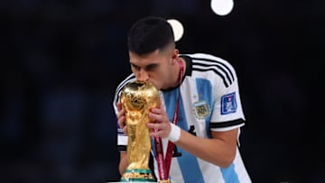 LUSAIL CITY, QATAR - DECEMBER 18: Exequiel Palacios of Argentina kisses and celebrates with the world cup trophy after the FIFA World Cup Qatar 2022 Final match between Argentina and France at Lusail Stadium on December 18, 2022 in Lusail City, Qatar. (Photo by Marc Atkins/Getty Images)