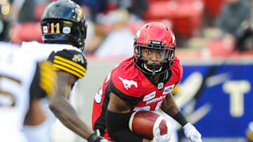 CALGARY, AB - JUNE 16: Don Jackson #25 of the Calgary Stampeders carries the ball against Larry Dean #11 of the Hamilton Tiger-Cats during a CFL game at McMahon Stadium on June 16, 2018 in Calgary, Alberta, Canada. (Photo by Derek Leung/Getty Images)