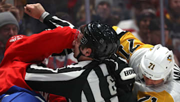 WASHINGTON, DC - FEBRUARY 23: Linesman James Tobias breaks up Evgeni Malkin #71 of the Pittsburgh Penguins and Brenden Dillon #4 of the Washington Capitals during the first period at Capital One Arena on February 23, 2020 in Washington, DC. (Photo by Patrick Smith/Getty Images)