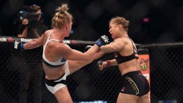 Nov 15, 2015; Melbourne, Australia; Ronda Rousey (red gloves) competes against Holly Holm (blue gloves) during UFC 193 at Etihad Stadium. Mandatory Credit: Matt Roberts-USA TODAY Sports
