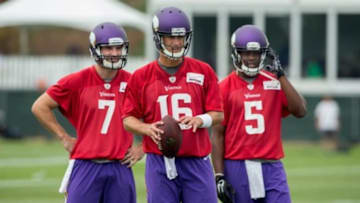 Jul 25, 2014; Mankato, MN, USA; Minnesota Vikings quarterback Christian Ponder (7) and quarterback Matt Cassel (16) and quarterback Teddy Bridgewater (5) await drills at training camp at Minnesota State University. Mandatory Credit: Bruce Kluckhohn-USA TODAY Sports