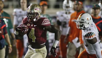 Oct 10, 2015; Tallahassee, FL, USA; Florida State Seminoles running back Dalvin Cook (4) runs past Miami Hurricanes linebacker Raphael Kirby (56) after catching a pass for a 36-yard touchdown, his second of the first quarter, at Doak Campbell Stadium. Mandatory Credit: Phil Sears-USA TODAY Sports