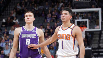 SACRAMENTO, CA - DECEMBER 29: Devin Booker #1 of the Phoenix Suns faces off against Bogdan Bogdanovic #8 of the Sacramento Kings on December 29, 2017 at Golden 1 Center in Sacramento, California. NOTE TO USER: User expressly acknowledges and agrees that, by downloading and or using this photograph, User is consenting to the terms and conditions of the Getty Images Agreement. Mandatory Copyright Notice: Copyright 2017 NBAE (Photo by Rocky Widner/NBAE via Getty Images)