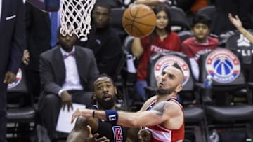 WASHINGTON, USA - DECEMBER 15: Los Angeles Clipper DeAndre Jordan (6) and Washington Wizard Marcin Gortat (13) go for a rebound at the Capital One Arena in Washington, USA on December 15, 2017. (Photo by Samuel Corum/Anadolu Agency/Getty Images)