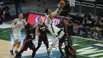 May 24, 2021; Milwaukee, Wisconsin, USA; Milwaukee Bucks forward Giannis Antetokounmpo (34) drives to the basket against Miami Heat forward Trevor Ariza (8) and guard Duncan Robinson (55) in the first quarter during game 2 in the first round of the 2021 NBA Playoffs at Fiserv Forum. Mandatory Credit: Michael McLoone-USA TODAY Sports