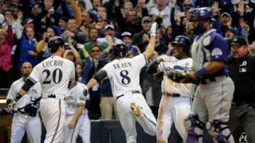 Apr 1, 2013; Milwaukee, WI, USA; Milwaukee Brewers left fielder Ryan Braun (8) gets a high-five from second baseman Rickie Weeks (23) after scoring the go-ahead run in the 8th inning during the game against the Colorado Rockies at Miller Park. Mandatory Credit: Benny Sieu-USA Today Sports