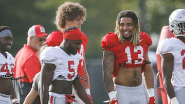 Ohio State Buckeyes tight end Gee Scott Jr. (13) talks to Ohio State Buckeyes cornerback Marcus Williamson (5) during football training camp at the Woody Hayes Athletic Center in Columbus on Tuesday, Aug. 10, 2021.Ohio State Football Training Camp