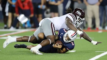 TUCSON, ARIZONA - SEPTEMBER 10: Defensive end Randy Charlton #5 of the Mississippi State Bulldogs sacks quarterback Jayden de Laura #7 of the Arizona Wildcats during the first half of the NCAA football game at Arizona Stadium on September 10, 2022 in Tucson, Arizona. (Photo by Rebecca Noble/Getty Images)