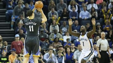 Apr 9, 2016; Memphis, TN, USA; Golden State Warriors guard Klay Thompson (11) shoots the ball as Memphis Grizzlies guard Lance Stephenson (1) defends at FedExForum. The Warriors won 100-99. Mandatory Credit: Nelson Chenault-USA TODAY Sports