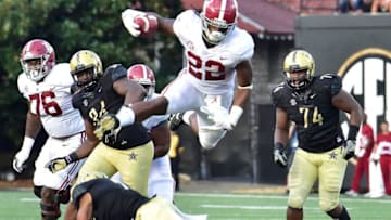 NASHVILLE, TN - SEPTEMBER 23: Najee Harris #22 of the Alabama Crimson Tide jumps over Arnold Tarpley III #2 of the Vanderbilt Commodores during the second half at Vanderbilt Stadium on September 23, 2017 in Nashville, Tennessee. (Photo by Frederick Breedon/Getty Images)