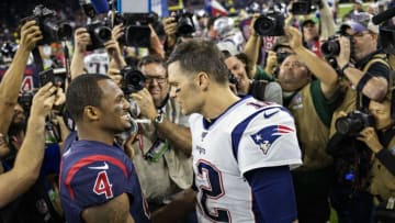 HOUSTON, TX - DECEMBER 1: Deshaun Watson #4 of the Houston Texans talks after the game on the field while surrounded by photographers to Tom Brady #12 of the New England Patriots at NRG Stadium on December 1, 2019 in Houston, Texas. The Texans defeated the Patriots 28-22. (Photo by Wesley Hitt/Getty Images)
