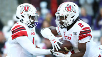 SEATTLE, WASHINGTON - NOVEMBER 02: Tyler Huntley #1 hands the ball off to Zack Moss #2 of the Utah Utes against the Washington Huskies in the first quarter during their game at Husky Stadium on November 02, 2019 in Seattle, Washington. (Photo by Abbie Parr/Getty Images)