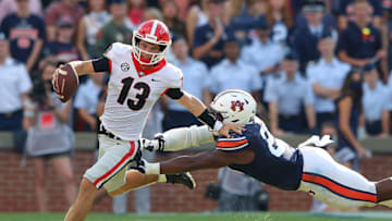 AUBURN, ALABAMA - OCTOBER 09: Stetson Bennett #13 of the Georgia Bulldogs rushes away from Colby Wooden #25 of the Auburn Tigers during the first half at Jordan-Hare Stadium on October 09, 2021 in Auburn, Alabama. (Photo by Kevin C. Cox/Getty Images)