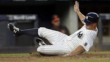 Jul 18, 2016; Bronx, NY, USA; New York Yankees left fielder Brett Gardner (11) scores a run against the Baltimore Orioles during the third inning at Yankee Stadium. Mandatory Credit: Adam Hunger-USA TODAY Sports