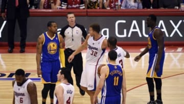 May 3, 2014; Los Angeles, CA, USA; Los Angeles Clippers guard Chris Paul (3) holds back Los Angeles Clippers forward Blake Griffin (32) as he tries to confront Golden State Warriors forward Andre Iguodala (9) during the third quarter in game seven of the first round of the 2014 NBA Playoffs at Staples Center. Mandatory Credit: Kelvin Kuo-USA TODAY Sports