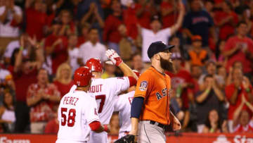 ANAHEIM, CA - SEPTEMBER 11: Pitcher Dallas Keuchel #60 of the Houston Astros looks on as Carlos Perez #58, Mike Trout #27 and Taylor Featherston #8 of the Los Angeles Angels of Anaheim celebrate at home plate after Perez and Featherston scored in the second inning during the MLB game at Angel Stadium of Anaheim on September 11, 2015 in Anaheim, California. (Photo by Victor Decolongon/Getty Images)