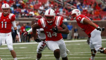 Oct 26, 2013; Dallas, TX, USA; Southern Methodist Mustangs running back Traylon Shead (34) rushes for a touchdown against Temple Owls during the first half of a college football game at Gerald J. Ford Stadium. Mandatory Credit: Jim Cowsert-USA TODAY Sports