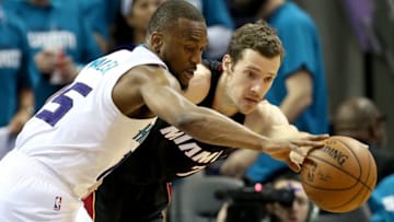 CHARLOTTE, NC - APRIL 25: Kemba Walker #15 of the Charlotte Hornets battles for a loose ball against Goran Dragic #7 of the Miami Heat during game four of the Eastern Conference Quarterfinals of the 2016 NBA Playoffs at Time Warner Cable Arena on April 25, 2016 in Charlotte, North Carolina. NOTE TO USER: User expressly acknowledges and agrees that, by downloading and or using this photograph, User is consenting to the terms and conditions of the Getty Images License Agreement. (Photo by Streeter Lecka/Getty Images)
