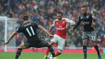 LONDON, ENGLAND - SEPTEMBER 10: Santi Cazorla of Arsenal takes on Dusan Tadic and Nathan Redmond of Southampton during the Premier League match between Arsenal and Southampton at Emirates Stadium on September 10, 2016 in London, England. (Photo by David Price/Arsenal FC via Getty Images)
