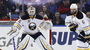 Jan 16, 2016; Buffalo, NY, USA; Buffalo Sabres goalie Chad Johnson (31) and defenseman Mike Weber (6) keep an eye on a Washington Capitals shot during the second period at First Niagara Center. Mandatory Credit: Kevin Hoffman-USA TODAY Sports