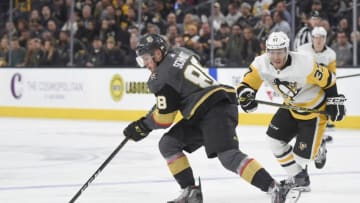 LAS VEGAS, NV - DECEMBER 14: Nate Schmidt #88 of the Vegas Golden Knights and Carter Rowney #37 of the Pittsburgh Penguins skate to the puck during the game at T-Mobile Arena on December 14, 2017 in Las Vegas, Nevada. (Photo by David Becker/NHLI via Getty Images)