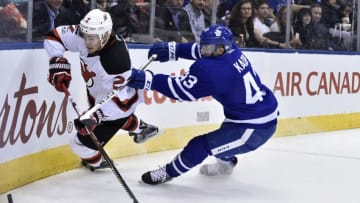 TORONTO, ON - MARCH 23: Toronto Maple Leafs Center Nazem Kadri (43) and New Jersey Devils Defenceman John Moore (2) fight for the puck mduring the regular season NHL game between the New Jersey Devils and Toronto Maple Leafs on March 23, 2017 at Air Canada Centre in Toronto, ON. (Photo by Gerry Angus/Icon Sportswire via Getty Images)