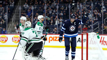 Nov 2, 2021; Winnipeg, Manitoba, CAN; Winnipeg Jets right wing Blake Wheeler (26) celebrates the second period goal by Winnipeg Jets defenseman Josh Morrissey (44) on Dallas Stars goaltender Braden Holtby (70) at Canada Life Centre. Mandatory Credit: James Carey Lauder-USA TODAY Sports