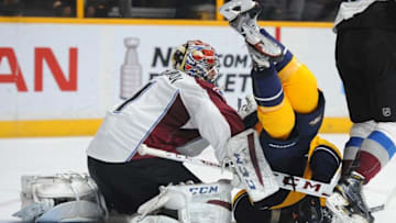 Mar 28, 2016; Nashville, TN, USA; Nashville Predators right winger James Neal (18) is knocked down by Colorado Avalanche goalie Semyon Varlamov (1) during the first period at Bridgestone Arena. Mandatory Credit: Christopher Hanewinckel-USA TODAY Sports
