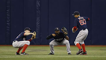 Sep 23, 2016; St. Petersburg, FL, USA; Boston Red Sox left fielder Brock Holt (12), center fielder Jackie Bradley Jr. (25) and right fielder Mookie Betts (50) congratulate each other after they beat the Tampa Bay Rays at Tropicana Field. Boston Red Sox defeated the Tampa Bay Rays 2-1. Mandatory Credit: Kim Klement-USA TODAY Sports