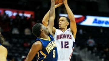 Oct 22, 2013; Atlanta, GA, USA; Atlanta Hawks shooting guard John Jenkins (12) attempts a shot over Indiana Pacers small forward Solomon Hill (9) in the first half at Philips Arena. Mandatory Credit: Daniel Shirey-USA TODAY Sports