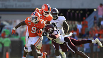 CLEMSON, SOUTH CAROLINA - SEPTEMBER 07: Keldrick Carper #14 of the Texas A&M Aggies tries to stop Travis Etienne #9 of the Clemson Tigers during their game at Memorial Stadium on September 07, 2019 in Clemson, South Carolina. (Photo by Streeter Lecka/Getty Images)