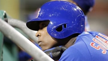 May 22, 2013; Pittsburgh, PA, USA; Chicago Cubs left fielder Alfonso Soriano (12) looks on as he waits his turn to bat on the dugout steps against the Pittsburgh Pirates during the eighth inning at PNC Park. The Pittsburgh Pirates won 1-0. Mandatory Credit: Charles LeClaire-USA TODAY Sports